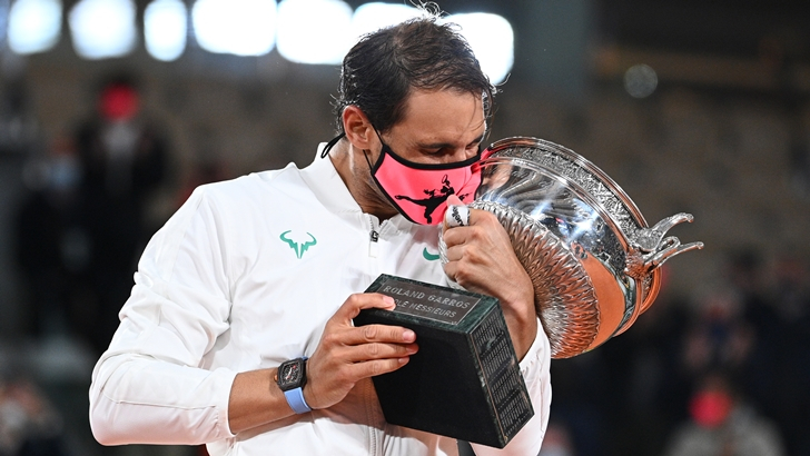 Spain’s Rafael Nadal kisses the Mousquetaires Cup (The Musketeers) as he celebrates during the podium ceremony after winning the men’s singles final tennis match against Serbia’s Novak Djokovic at the Philippe Chatrier court, on Day 15 of The Roland Garros 2020 French Open tennis tournament in Paris on October 11, 2020. (Photo by Anne-Christine POUJOULAT / AFP)