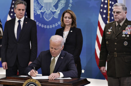 WASHINGTON, DC – MARCH 16: U.S. President Joe Biden signs legislative action to provide security aid and support to Ukraine as Secretary of State Antony Blinken (L), Deputy Secretary of Defense Kathleen Hicks and Chairman of the Joint Chiefs of Staff General Mark Milley look on, during an event in the South Court Auditorium at the Eisenhower Executive Office Building near the White House on March 16, 2022 in Washington, DC. President Biden delivered remarks on U.S. assistance to Ukraine as Russia’s invasion of Ukraine enters its third week.   Alex Wong/Getty Images/AFP (Photo by ALEX WONG / GETTY IMAGES NORTH AMERICA / Getty Images via AFP)