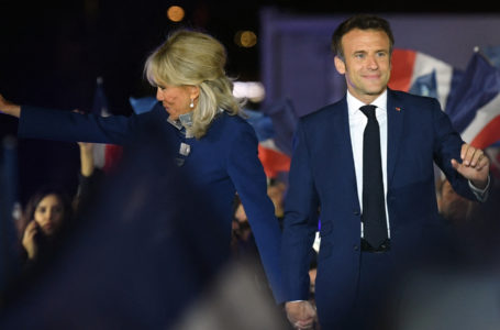 French President and La Republique en Marche (LREM) party candidate for re-election Emmanuel Macron and his wife Brigitte Macron celebrate after his victory in France’s presidential election, at the Champ de Mars in Paris, on April 24, 2022. (Photo by bERTRAND GUAY / AFP)