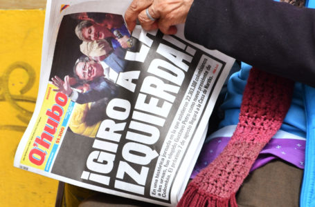A woman holds a local newspaper which front page reads Turn to the left! the day after the presidential candidate for the Historic Pact coalition, Gustavo Petro, was elected president on a tense election, in Bogota, on June 20, 2022. – Ex-guerrilla Gustavo Petro was elected on Sunday as the first ever left-wing president of crisis-wracked Colombia after beating millionaire businessman rival Rodolfo Hernandez. (Photo by DANIEL MUNOZ / AFP)