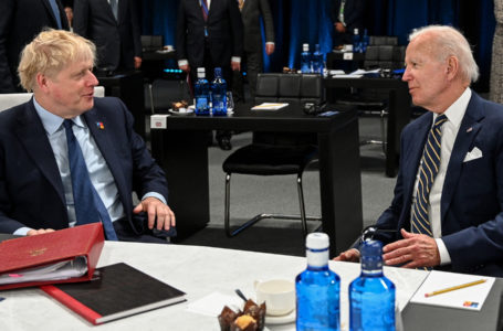 Britain’s Prime Minister Boris Johnson (L) and US President Joe Biden talk ahead of a meeting of The North Atlantic Council during the NATO summit at the Ifema congress centre in Madrid, on June 30, 2022. (Photo by GABRIEL BOUYS / AFP)