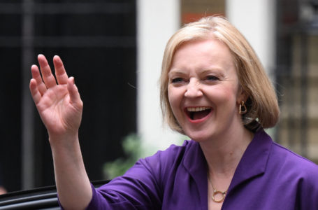 New Conservative Party leader and incoming prime minister Liz Truss smiles and waves as she arrives at Conservative Party Headquarters in central London having been announced the winner of the Conservative Party leadership contest at an event in central London on September 5, 2022. – Truss is the UK’s third female prime minister following Theresa May and Margaret Thatcher. The 47-year-old has consistently enjoyed overwhelming support over 42-year-old Sunak in polling of the estimated 200,000 Tory members who were eligible to vote. (Photo by Daniel LEAL / AFP)