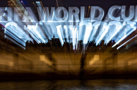 This long exposure picture shows people gathering in front of the FIFA World Cup Sign at Corniche promenade in Doha on November 18, 2022, ahead of the Qatar 2022 World Cup football tournament. (Photo by Philip FONG / AFP)