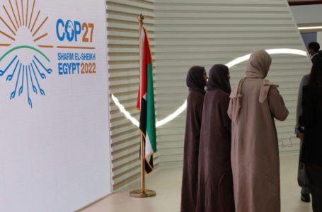 Muslim women walk past the COP27 sign at the Sharm el-Sheikh International Convention Centre, in Egypt’s Red Sea resort city of the same name, during the COP27 climate conference on Novmeber 15, 2022. (Photo by Joseph EID / AFP)