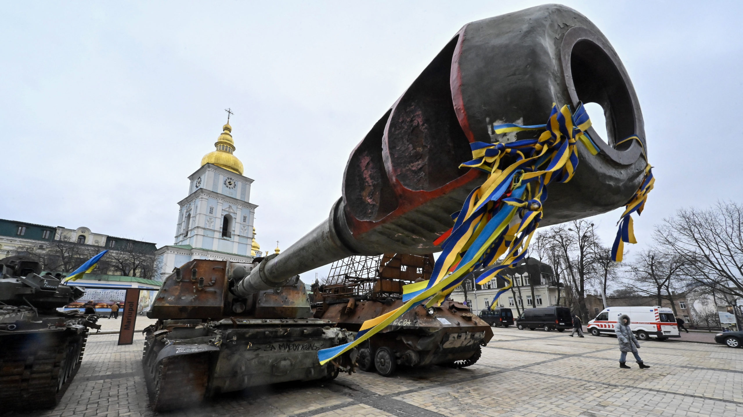 A person walks past destroyed Russian military vehicles displyed in an open air exhibition in Kyiv on February 24, 2023, on the first anniversary of the Russian invasion of Ukraine. (Photo by GENYA SAVILOV / AFP)