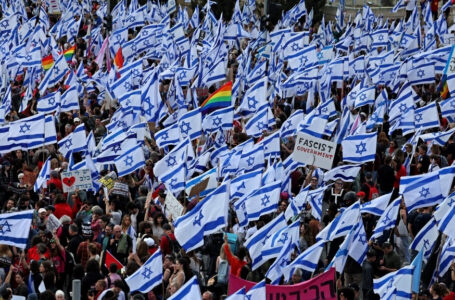 Protesters gather with national flags outside Israel’s parliament in Jerusalem amid ongoing demonstrations and calls for a general strike against the hard-right government’s controversial push to overhaul the justice system, on March 27, 2023. (Photo by AHMAD GHARABLI / AFP)