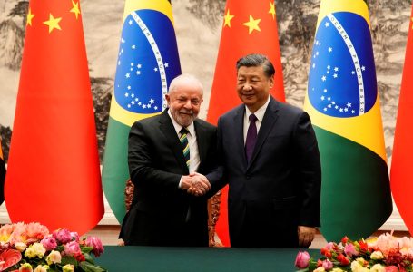 Chinese President Xi Jinping (R) and Brazil’s President Luiz Inacio Lula da Silva shake hands after a signing ceremony at the Great Hall of the People in Beijing on April 14, 2023. (Photo by Ken Ishii / POOL / AFP)